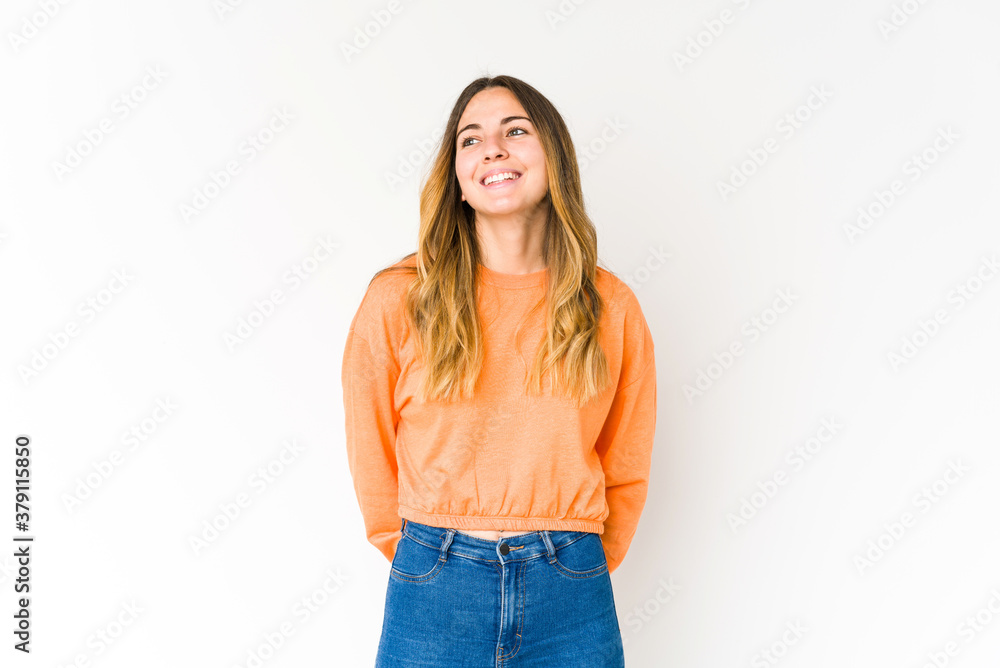 Young caucasian woman isolated on white background relaxed and happy laughing, neck stretched showing teeth. Young caucasian woman isolated on white background relaxed and happy laughing, neck stretched showing teeth.
