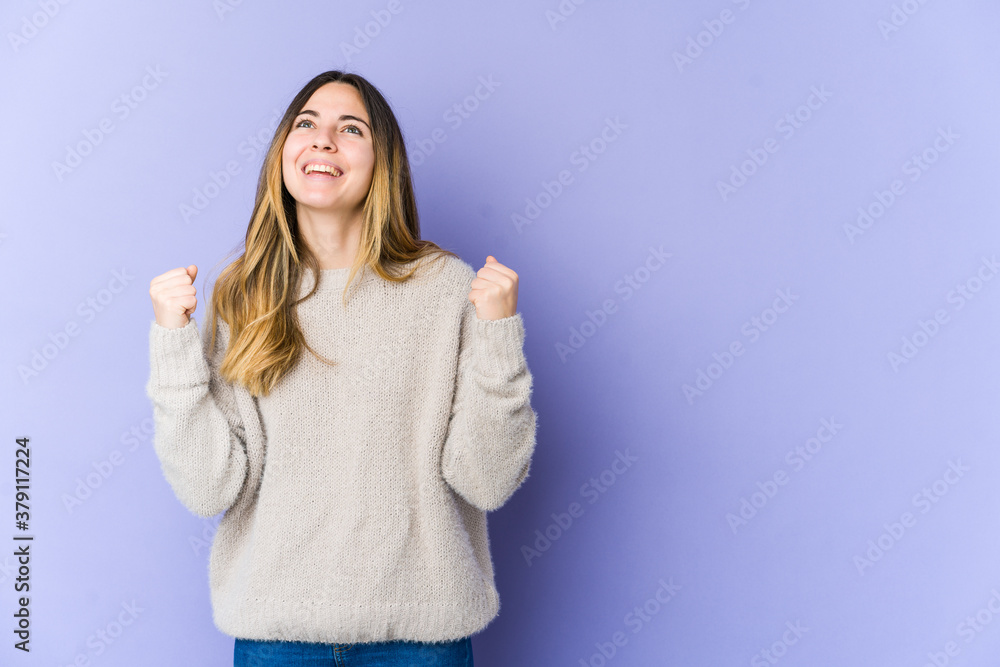 Young caucasian woman isolated on purple background celebrating a victory, passion and enthusiasm, happy expression. Young caucasian woman isolated on purple background celebrating a victory, passion and enthusiasm, happy expression.