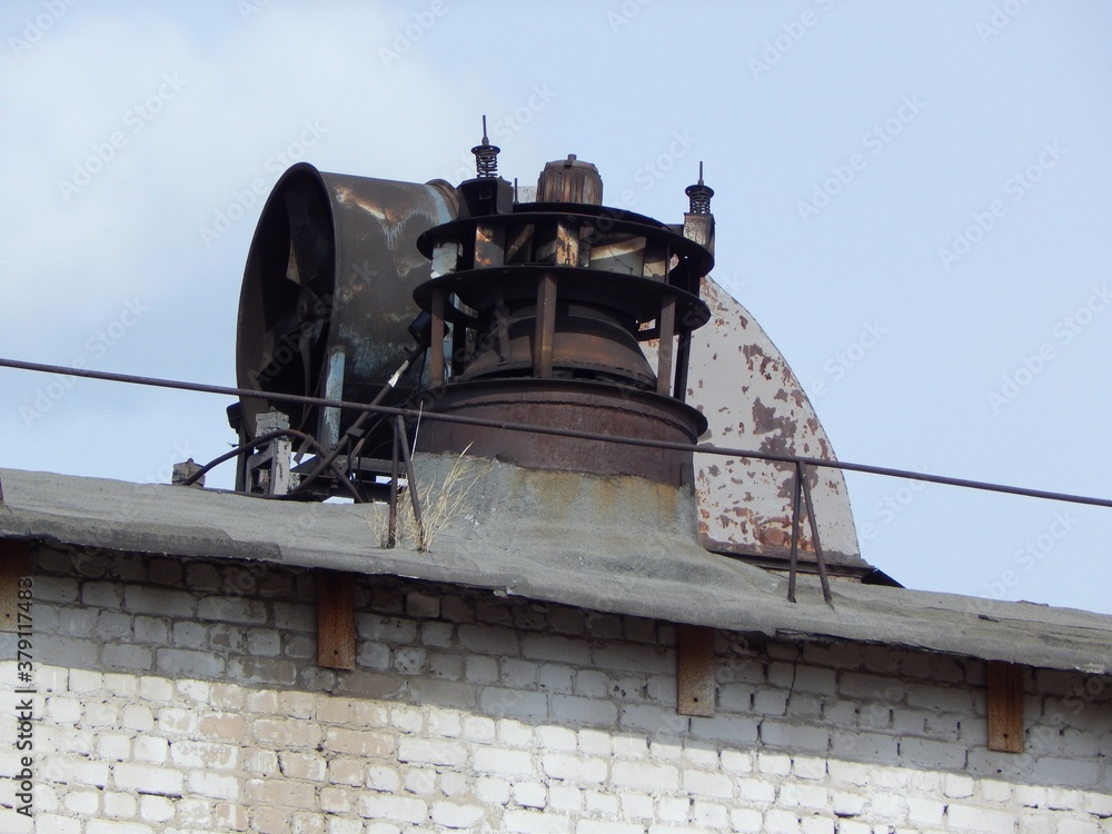 Old electric industrial fans close-up. Industrial fans on the roof of the factory floor. Old electric industrial fans close-up. Industrial fans on the roof of the factory floor.