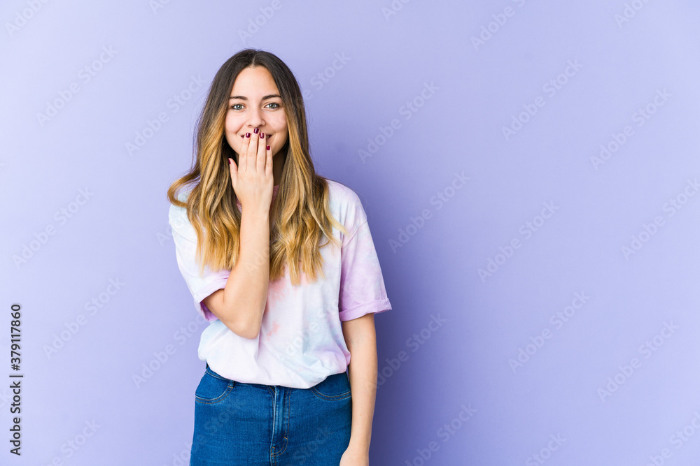 Young caucasian woman isolated on purple background shocked, covering mouth with hands, anxious to discover something new. Young caucasian woman isolated on purple background shocked, covering mouth with hands, anxious to discover something new.