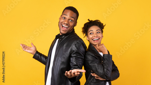 Photos Cheerful African Boyfriend And Girlfriend Standing Back-To-Back Over Yellow Back