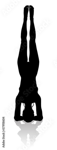 A silhouette of a woman in a yoga or pilates pose