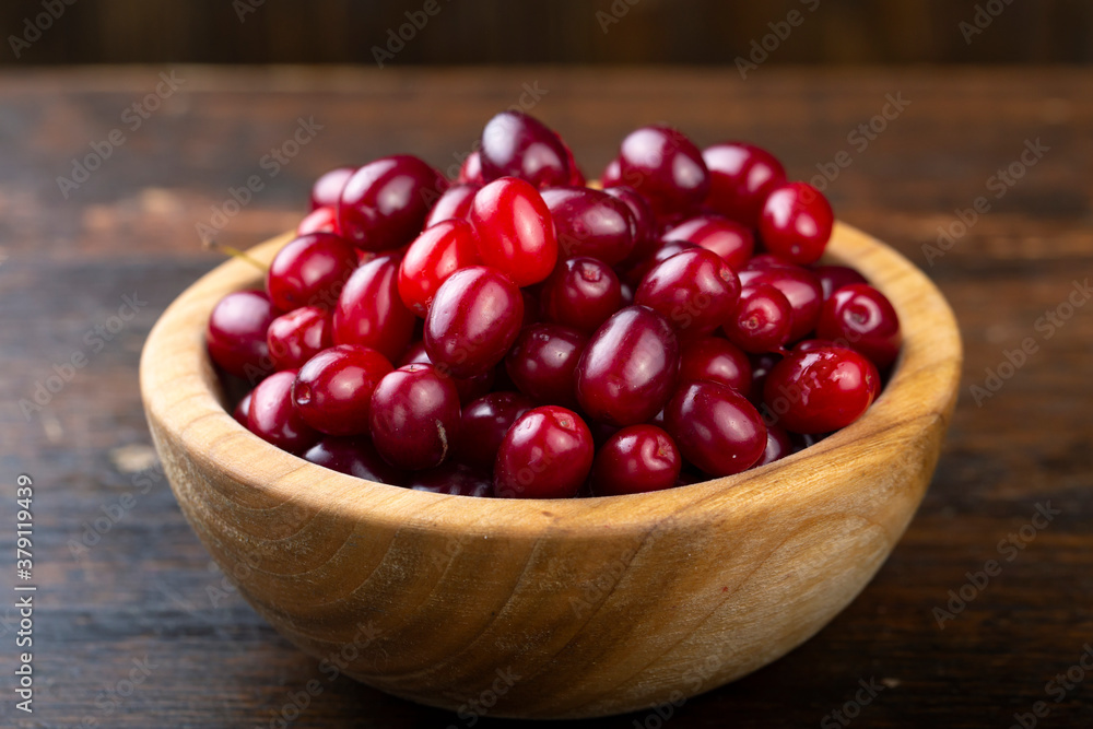 Dogwood berries in a wooden bowl Dogwood berries in a wooden bowl