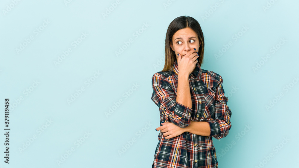 Young woman isolated on blue background scared and afraid. Young woman isolated on blue background scared and afraid.