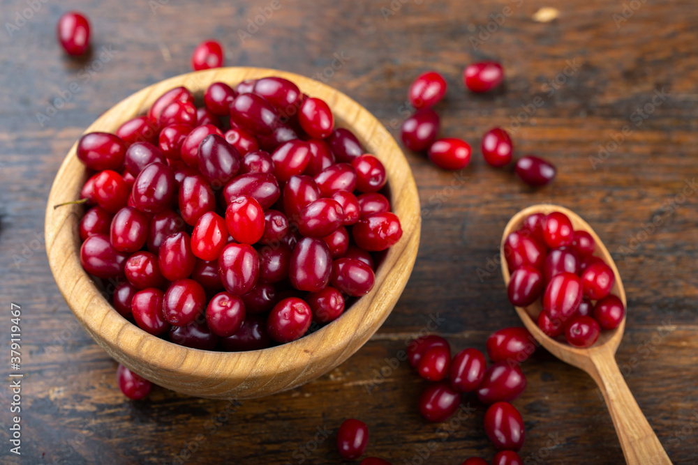 Dogwood berries in a wooden bowl Dogwood berries in a wooden bowl