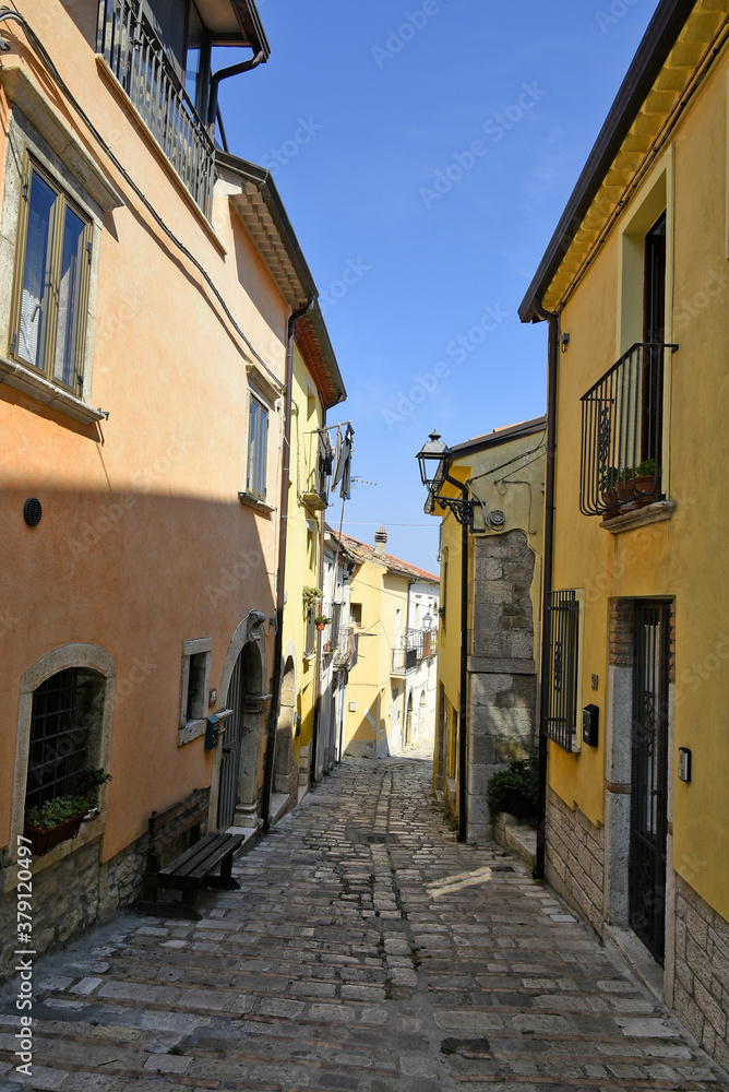 A narrow street among the old houses of Baselice, a small town in the province of Benevento, Italy.