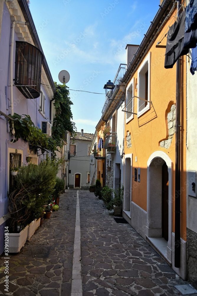 A narrow street among the old houses of Baselice, a small town in the province of Benevento, Italy.