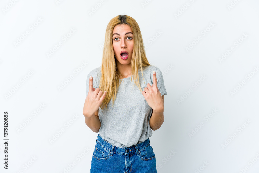 Young blonde woman isolated on white background pointing upside with opened mouth. Young blonde woman isolated on white background pointing upside with opened mouth.