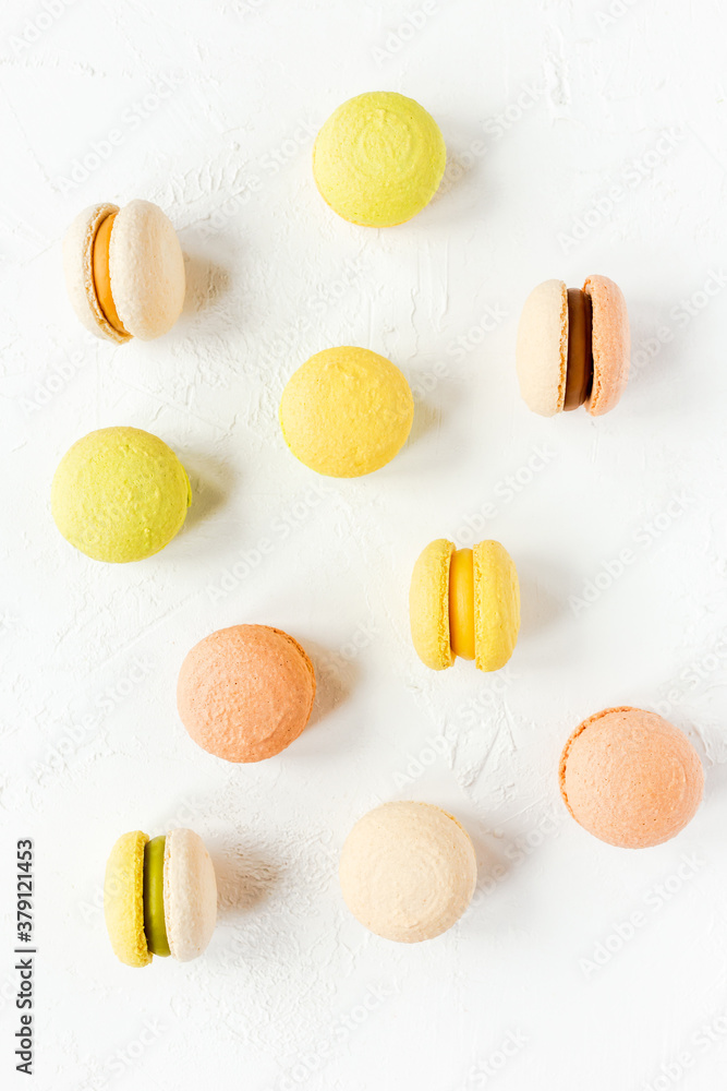 Colorful french macarons on white background, flatlay, top view Colorful french macarons on white background, flatlay, top view