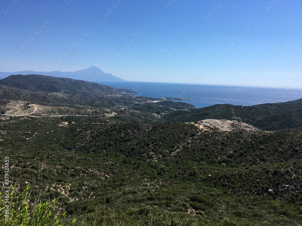 Mountain landscape on sunny summer day with clear sky in Greece with sea on background
