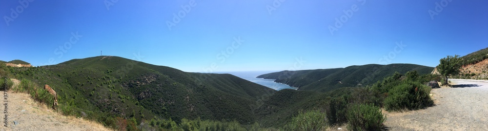 Mountain landscape panorama on sunny summer day with clear sky in Greece with sea gulf on background