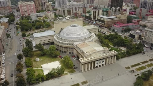 The flying camera shows the main attractions of Novosibirsk with a view of the city from and road traffic.