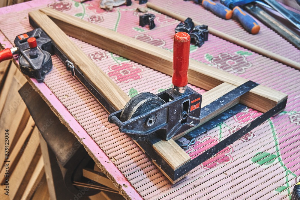 Joinery. Gluing and clamping wooden table leg. Wooden furniture manufacturing process. Furniture manufacture Joinery. Gluing and clamping wooden table leg. Wooden furniture manufacturing process. Furniture manufacture