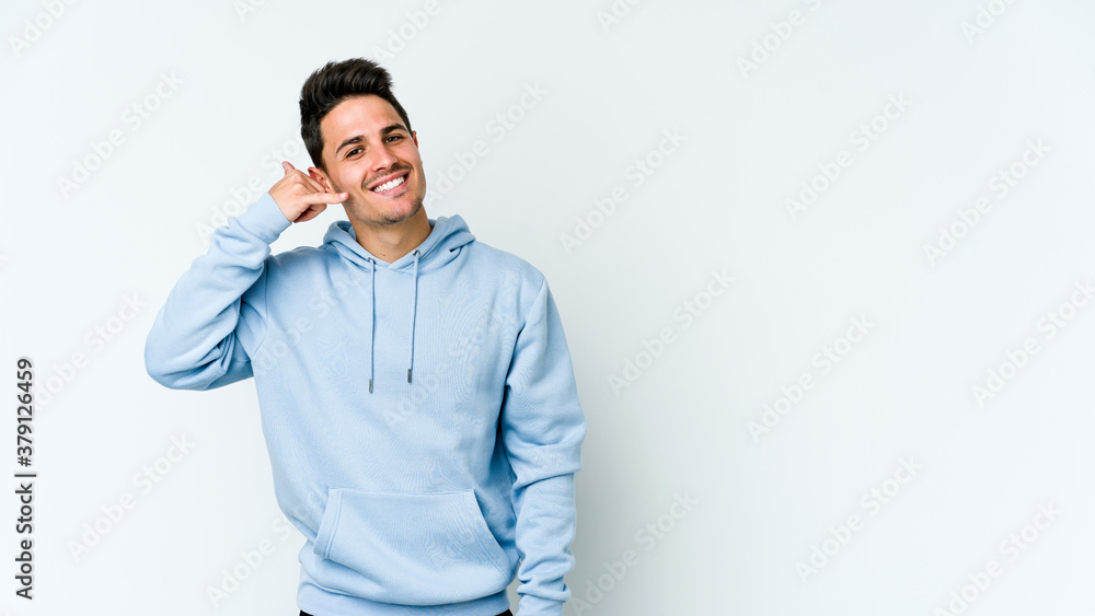 Young caucasian man isolated on white background showing a mobile phone call gesture with fingers. Young caucasian man isolated on white background showing a mobile phone call gesture with fingers.
