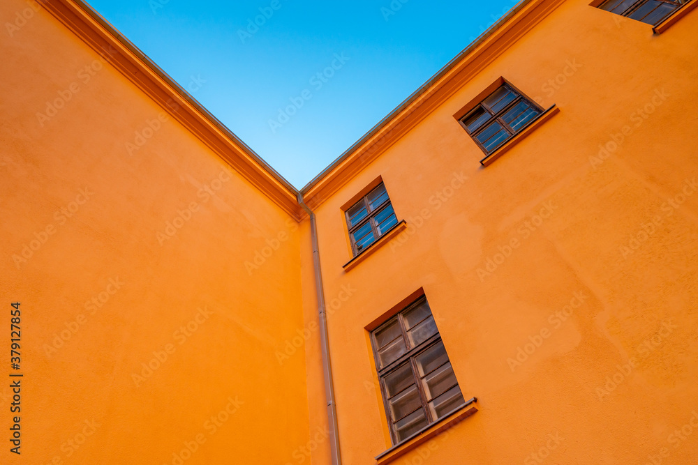 Old orange industrial building under blue sky
