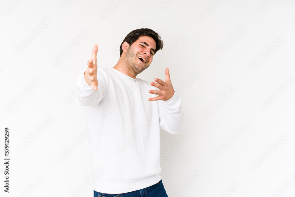 Young man isolated on white background feels confident giving a hug to the camera. Young man isolated on white background feels confident giving a hug to the camera.
