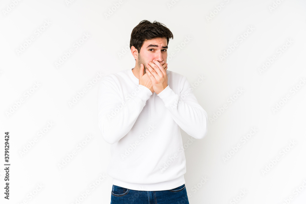 Young man isolated on white background covering mouth with hands looking worried. Young man isolated on white background covering mouth with hands looking worried.