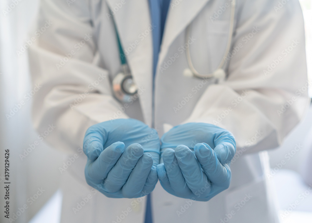 Medical doctor or surgeon with empty hands in hygience lab gloves offering or holding copy space for health care, nursing, organ donation, hospital csr, or clinical charity concept Medical doctor or surgeon with empty hands in hygience lab gloves offering or holding copy space for health care, nursing, organ donation, hospital csr, or clinical charity concept