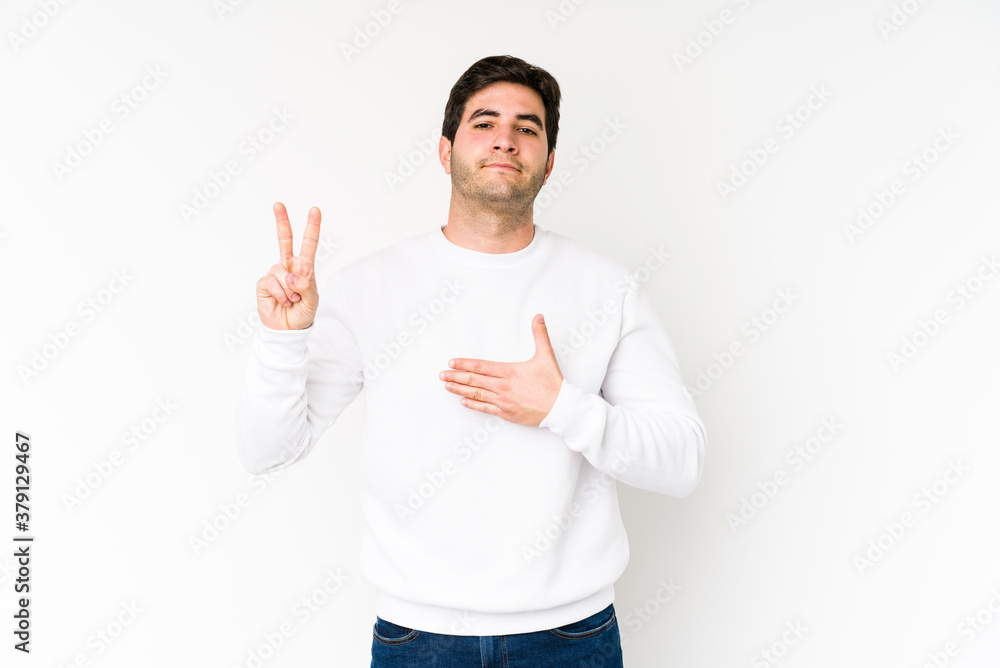 Young man isolated on white background taking an oath, putting hand on chest. Young man isolated on white background taking an oath, putting hand on chest.