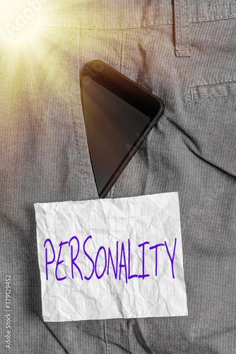 Text sign showing Personality. Business photo text the condition or fact of relating to a particular an individual Smartphone device inside formal work trousers front pocket near note paper photo