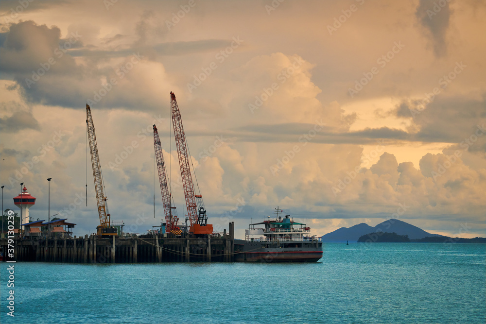 ranong seascape with sea dock and lighthouse in sunset skyline and cloud