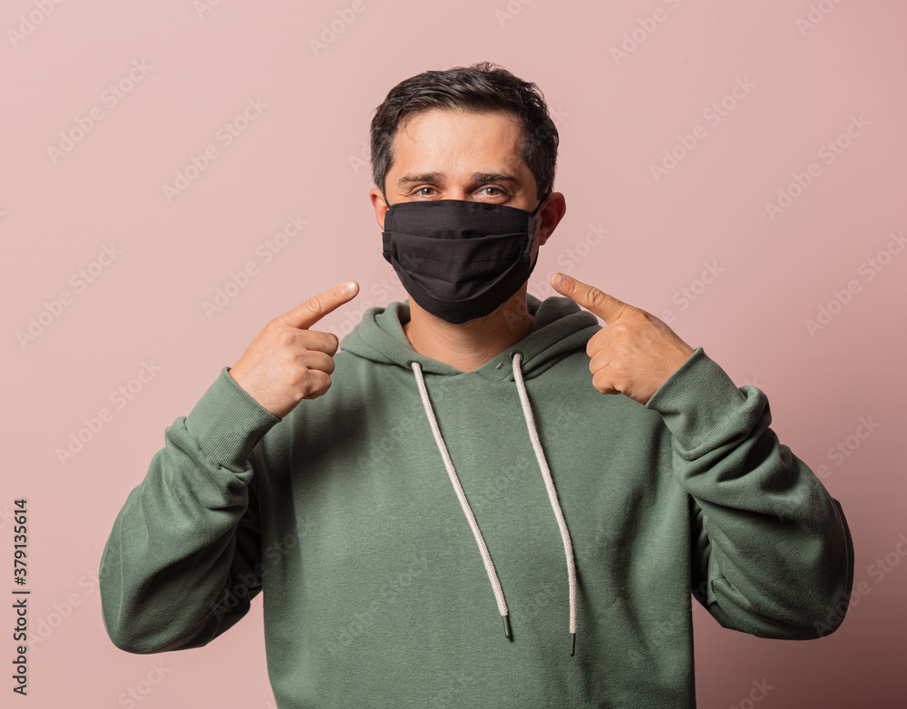 Portrit of man in face mask and green hoodie Portrit of man in face mask and green hoodie