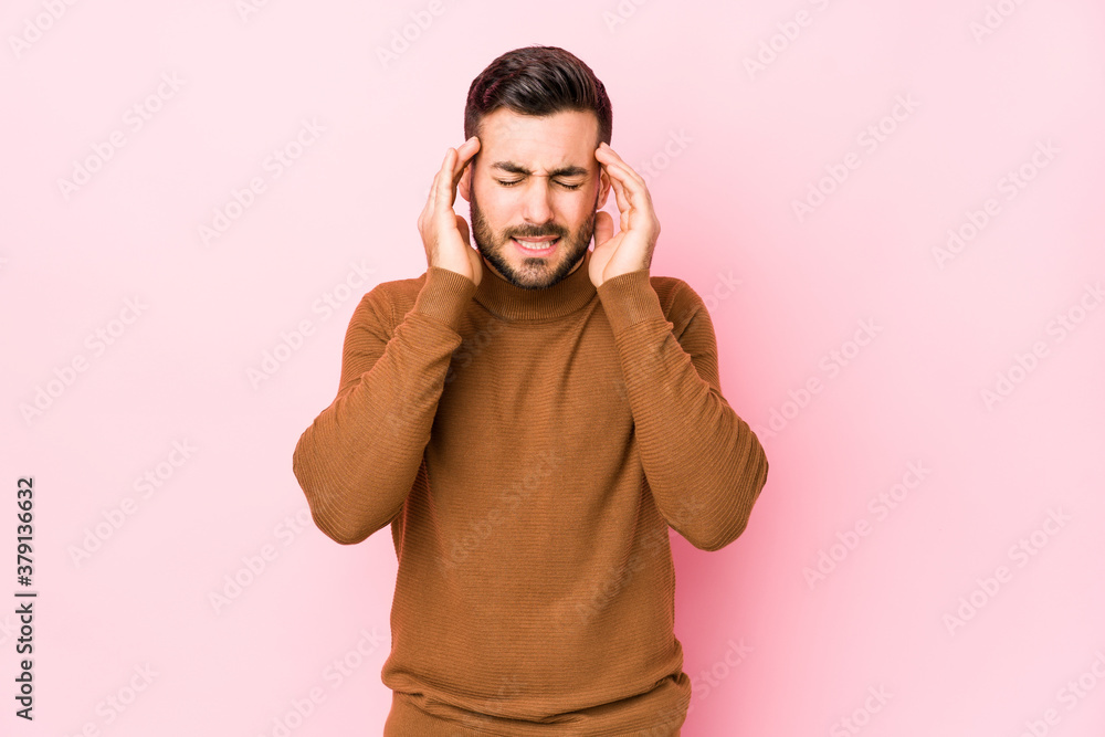 Young caucasian man against a pink background isolated touching temples and having headache. Young caucasian man against a pink background isolated touching temples and having headache.