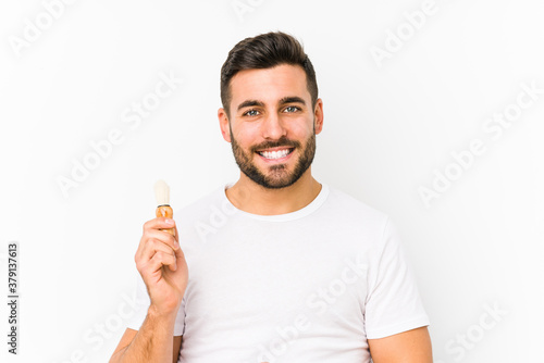 Young caucasian man recently shaving isolated smiling confident with crossed arms.