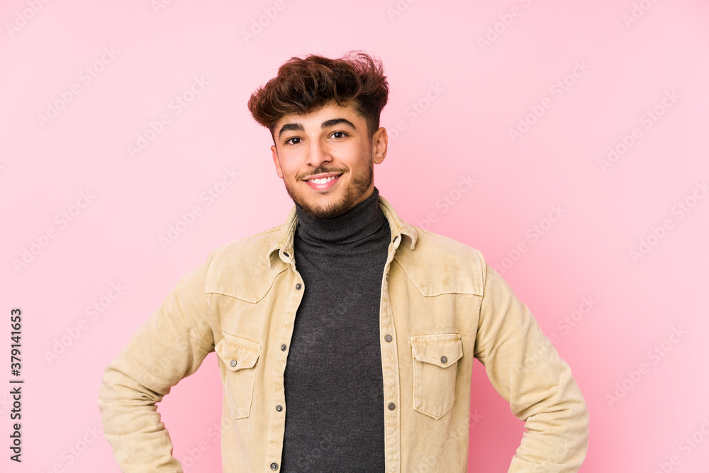Young arabian man posing in a background isolated confident keeping hands on hips. Young arabian man posing in a background isolated confident keeping hands on hips.