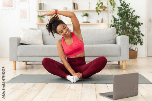 Black Woman Exercising At Laptop Having Online Training At Home