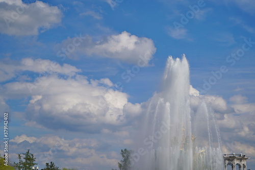 Fountain on the blue sky with clouds in the spring.