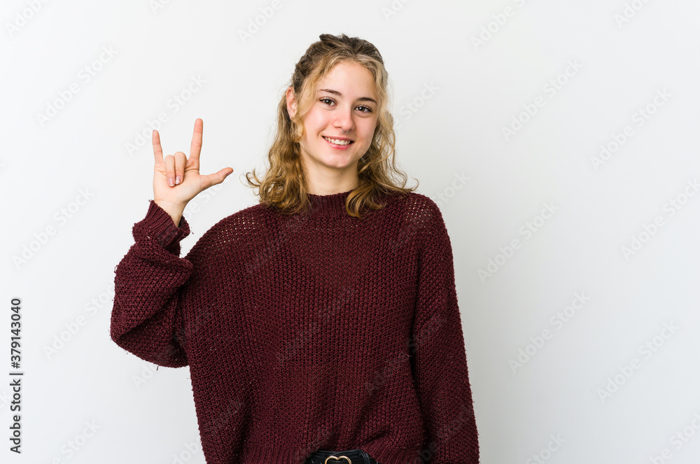 Young caucasian woman on white backrgound showing a horns gesture as a revolution concept. Young caucasian woman on white backrgound showing a horns gesture as a revolution concept.