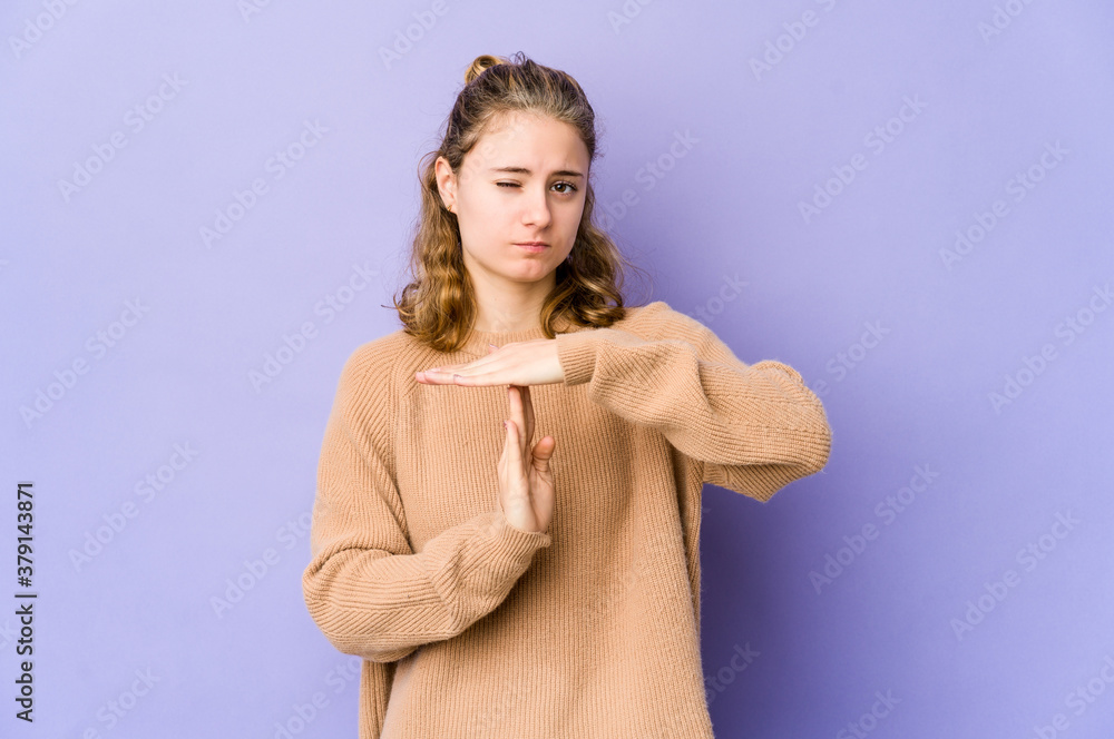 Young caucasian woman on purple background showing a timeout gesture. Young caucasian woman on purple background showing a timeout gesture.