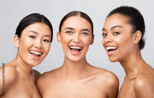 Three Cheerful Ladies Posing Shirtless Smiling To Camera In Studio
