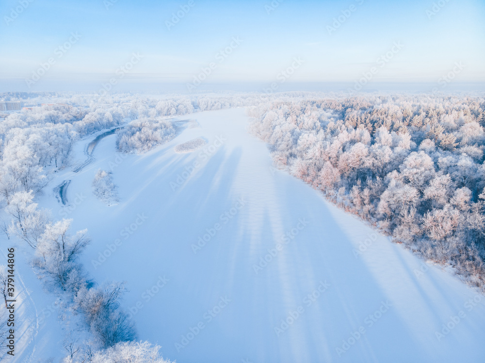 Aerial view to the winter Gaujas river and pines frozen forest and blue sky. Latvia. Aerial view to the winter Gaujas river and pines frozen forest and blue sky. Latvia.