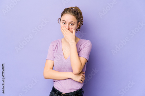 Young caucasian woman on purple background scared and afraid.