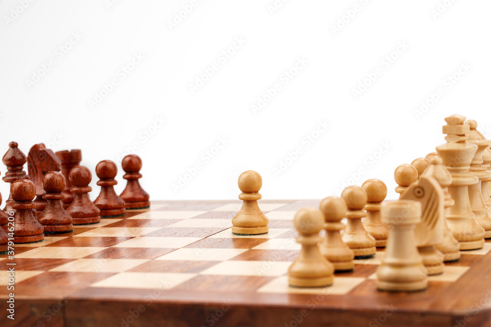 wooden chessboard with pieces and pawns in light and dark brown tones, isolate on a white background wooden chessboard with pieces and pawns in light and dark brown tones, isolate on a white background