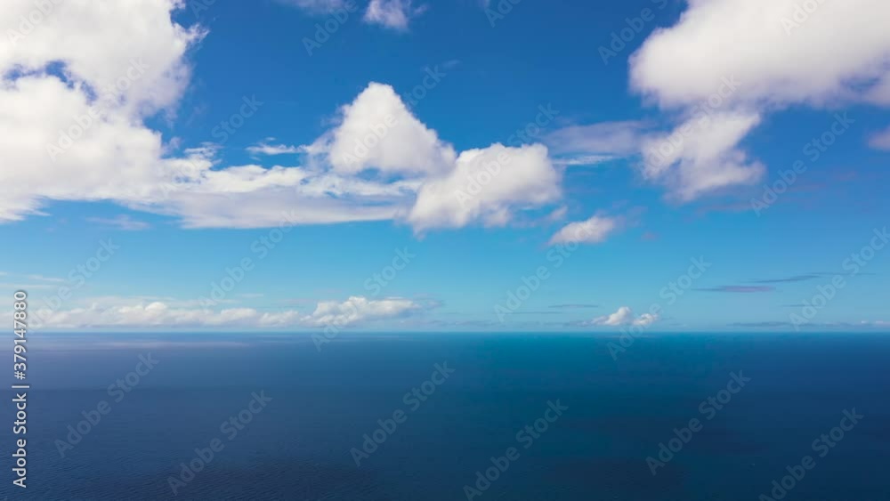 Tropical blue sea and blue sky with clouds. Seascape, aerial view. Flight over the sea. Summer and travel vacation concept. Tropical blue sea and blue sky with clouds. Seascape, aerial view. Flight over the sea. Summer and travel vacation concept.