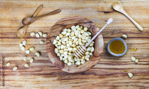 macadamia and honey on wooden background