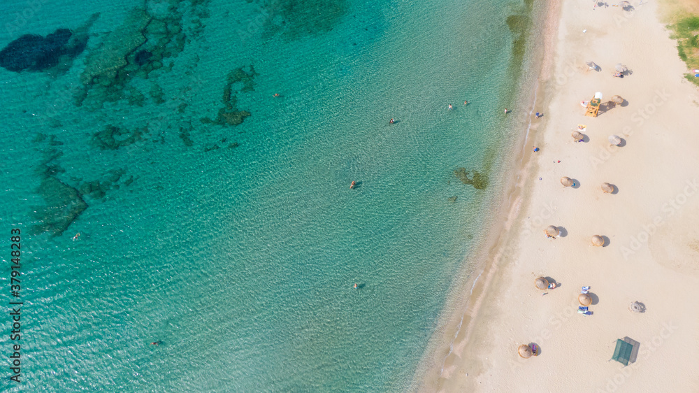 Aerial view of turquoise clear water and sandy beach of Ireon or Limni Vouliagmeni Lake in Peloponnese, Greece 