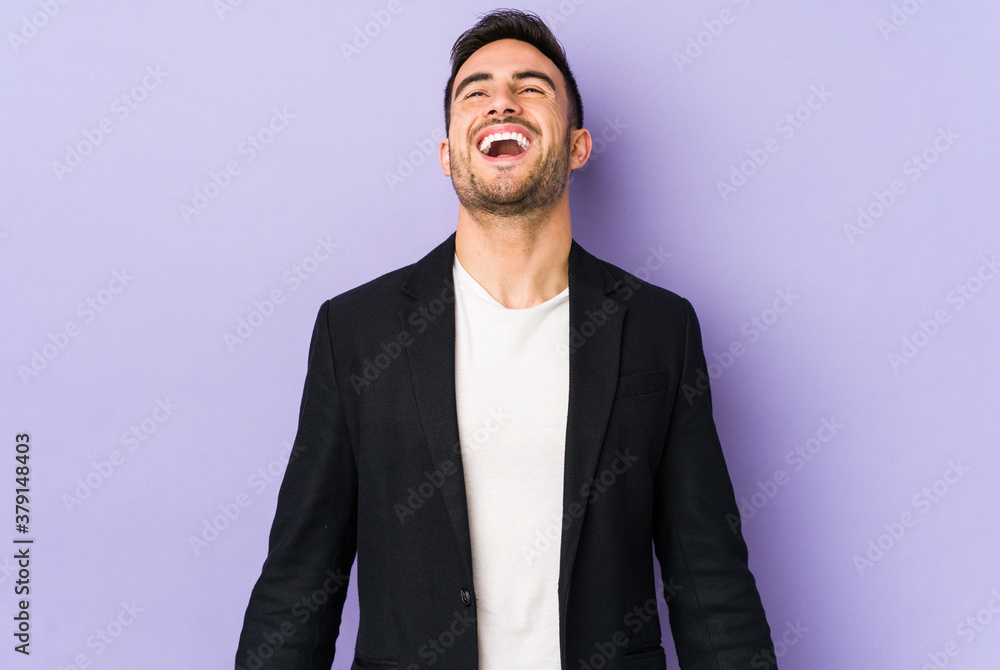 Young caucasian man isolated on purple background relaxed and happy laughing, neck stretched showing teeth. Young caucasian man isolated on purple background relaxed and happy laughing, neck stretched showing teeth.