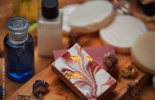 Shampoo and soap products on wooden board