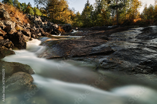 Long exposure of a river in autumn landscape. Wild nature of Norway, Hallingdal. 
