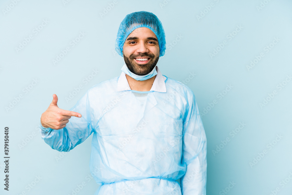 Young surgeon latin man isolated Young dperson pointing by hand to a shirt copy space, proud and confident Young surgeon latin man isolated Young dperson pointing by hand to a shirt copy space, proud and confident
