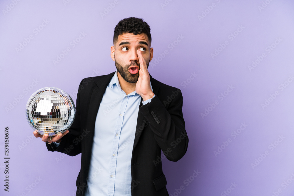 Young latin man holding a party ball isolated Young latin man holding a waffle isolated is saying a secret hot braking news and looking aside< mixto > Young latin man holding a party ball isolated Young latin man holding a waffle isolated is saying a secret hot braking news and looking aside< mixto >