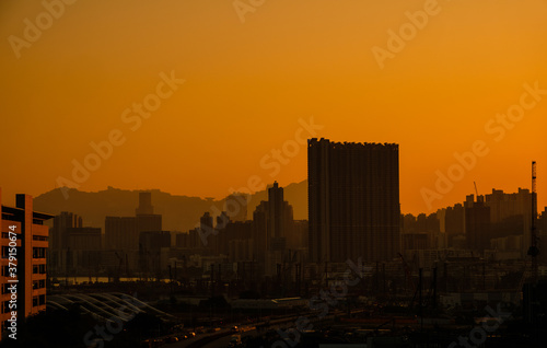 city skyline , skyscrapers, onstruction cranes and sunset sky in Hong Kong - © hanohiki