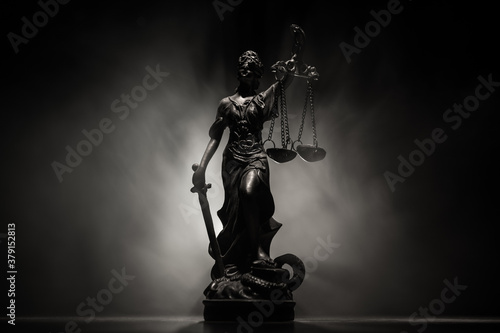 The Statue of Justice - lady justice or Iustitia / Justitia the Roman goddess of Justice on a dark fire background