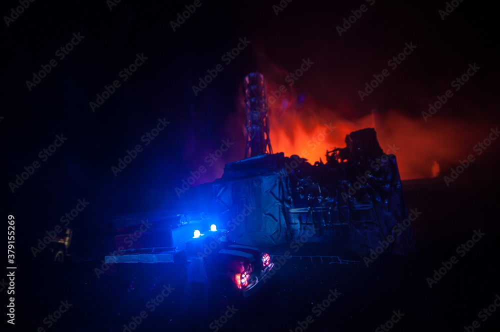 Chernobyl nuclear power plant at night. Layout of Chernobyl station during nuclear reactor explosion. Fire fighters at work. Selective focus