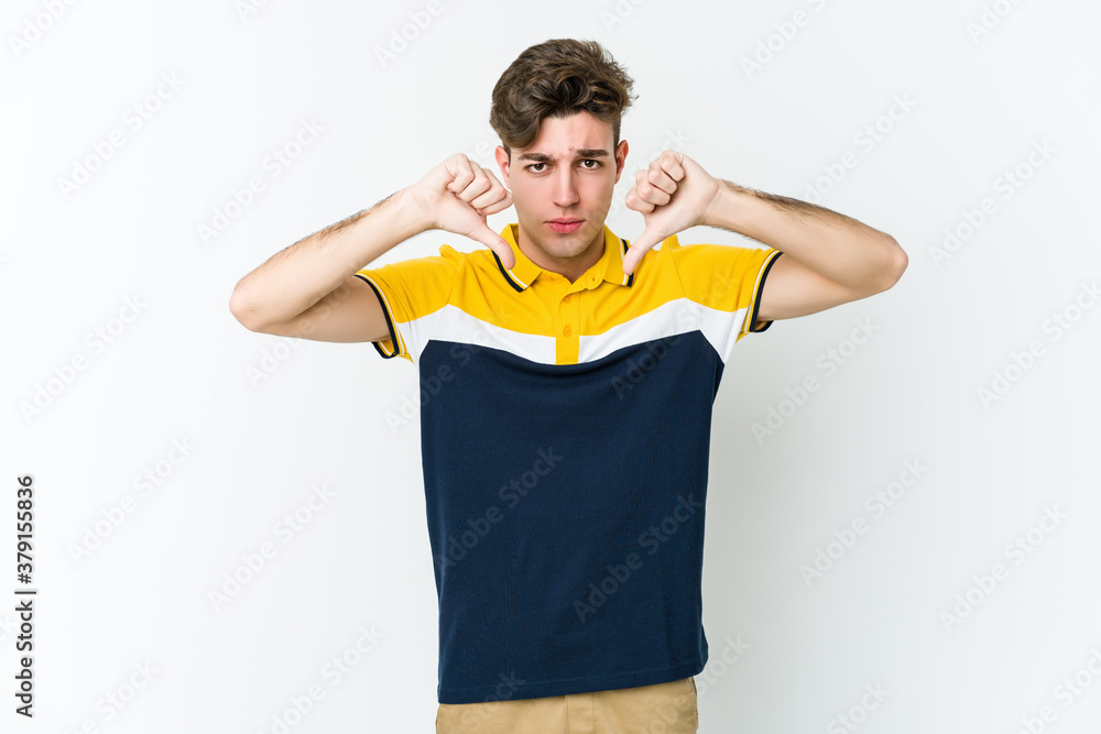 Young caucasian man isolated on white background showing a dislike gesture, thumbs down. Disagreement concept. Young caucasian man isolated on white background showing a dislike gesture, thumbs down. Disagreement concept.