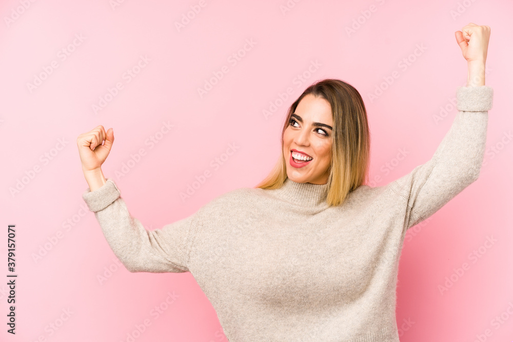Middle age woman over isolated background raising fist after a victory, winner concept. Middle age woman over isolated background raising fist after a victory, winner concept.